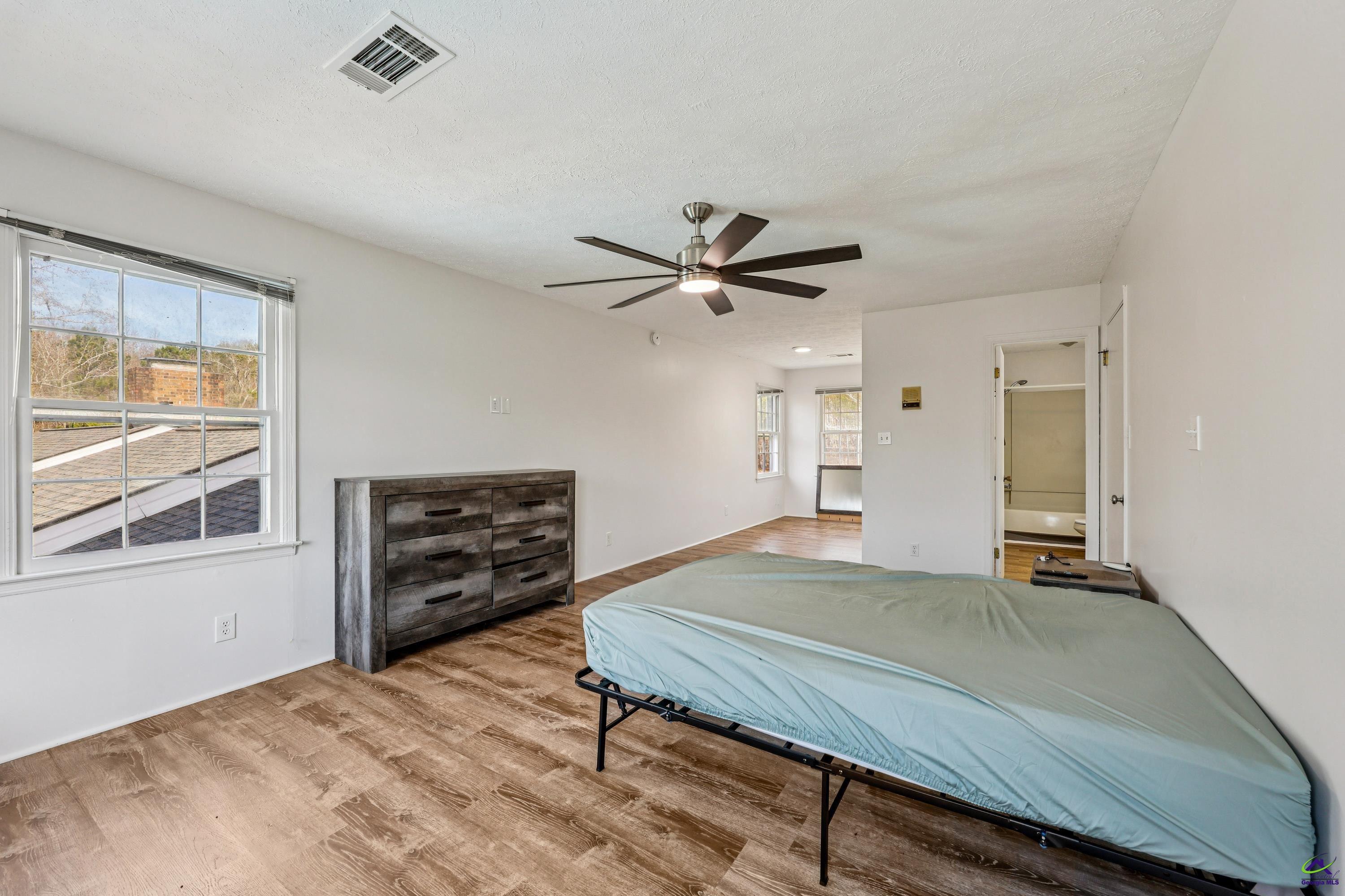 548 Greene Settlement Road Gray, GA 31032 - Photo 23 of 68 a bedroom with a bed and a window