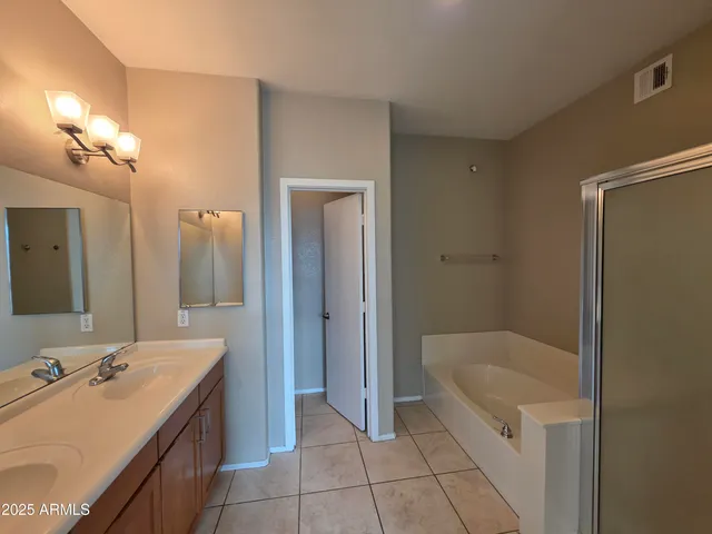a bathroom with a tub sink and mirror