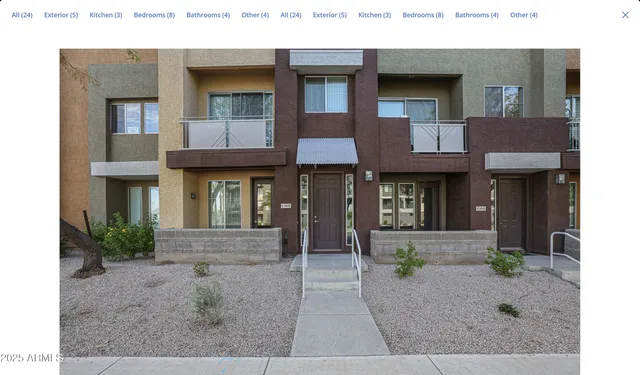 a front view of a brick house with many windows