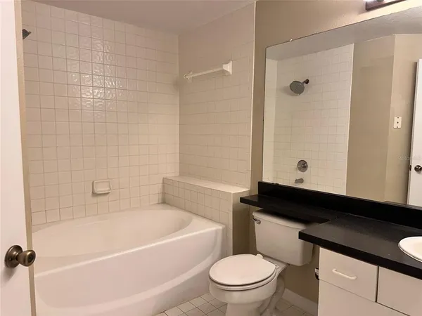 a bathroom with a toilet a sink and bathtub