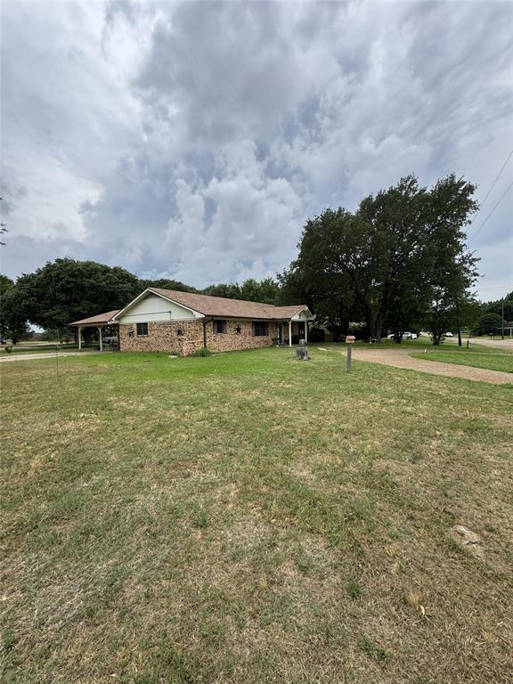636 East Kempner Street Mabank, TX 75147 - Photo 6 of 28 Brick exterior with white trim, covered front porch, and an attached carport