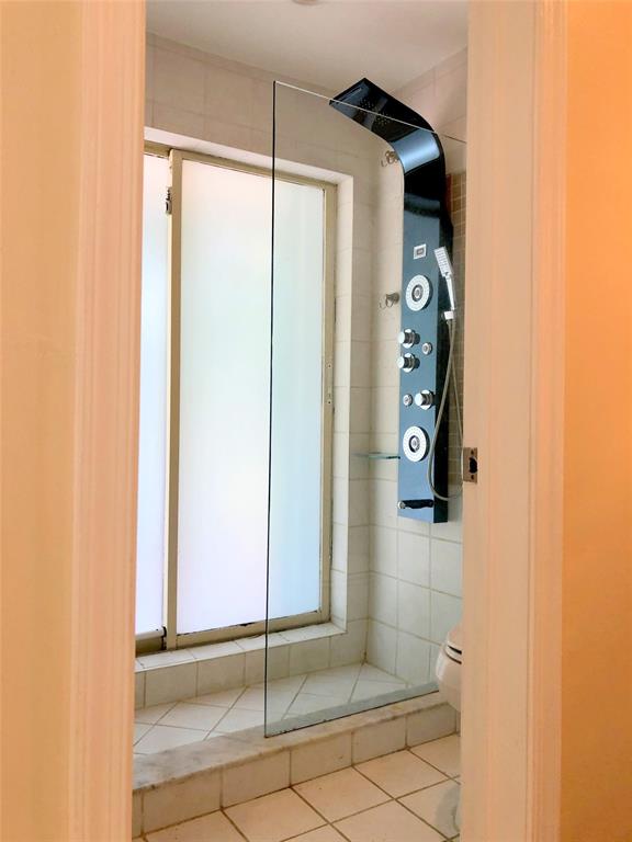 71 Laredo Lane Boca Raton, FL 33487 - Photo 13 of 18 a bathroom with a shower and a glass door