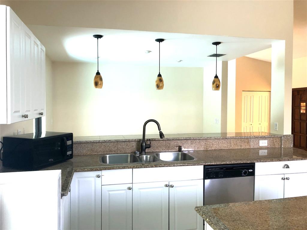 71 Laredo Lane Boca Raton, FL 33487 - Photo 8 of 18 a kitchen with granite countertop a stove a sink a window and dining table
