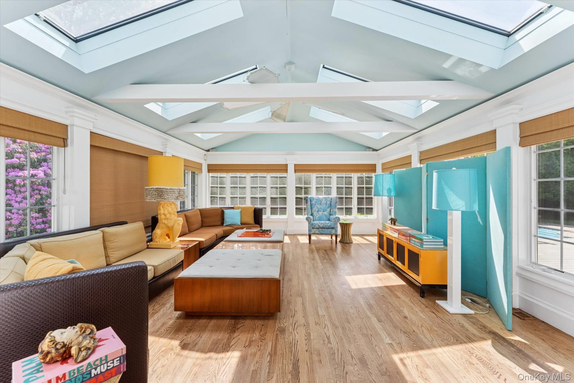 129 Oneck Lane Westhampton Beach, NY 11978 - Photo 13 of 32 a living room with furniture and floor to ceiling windows