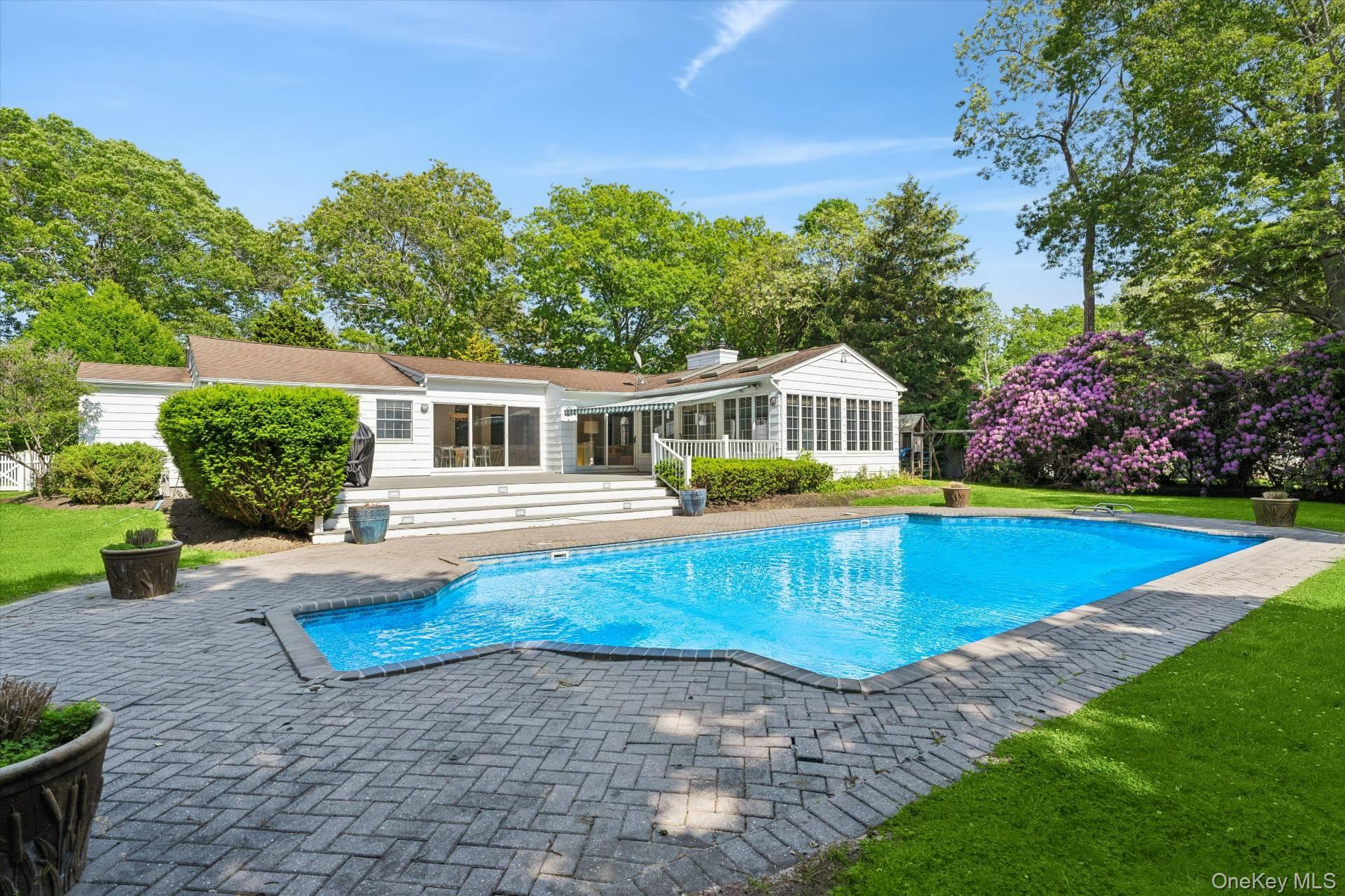 129 Oneck Lane Westhampton Beach, NY 11978 - Photo 23 of 32 a view of a house with swimming pool and yard