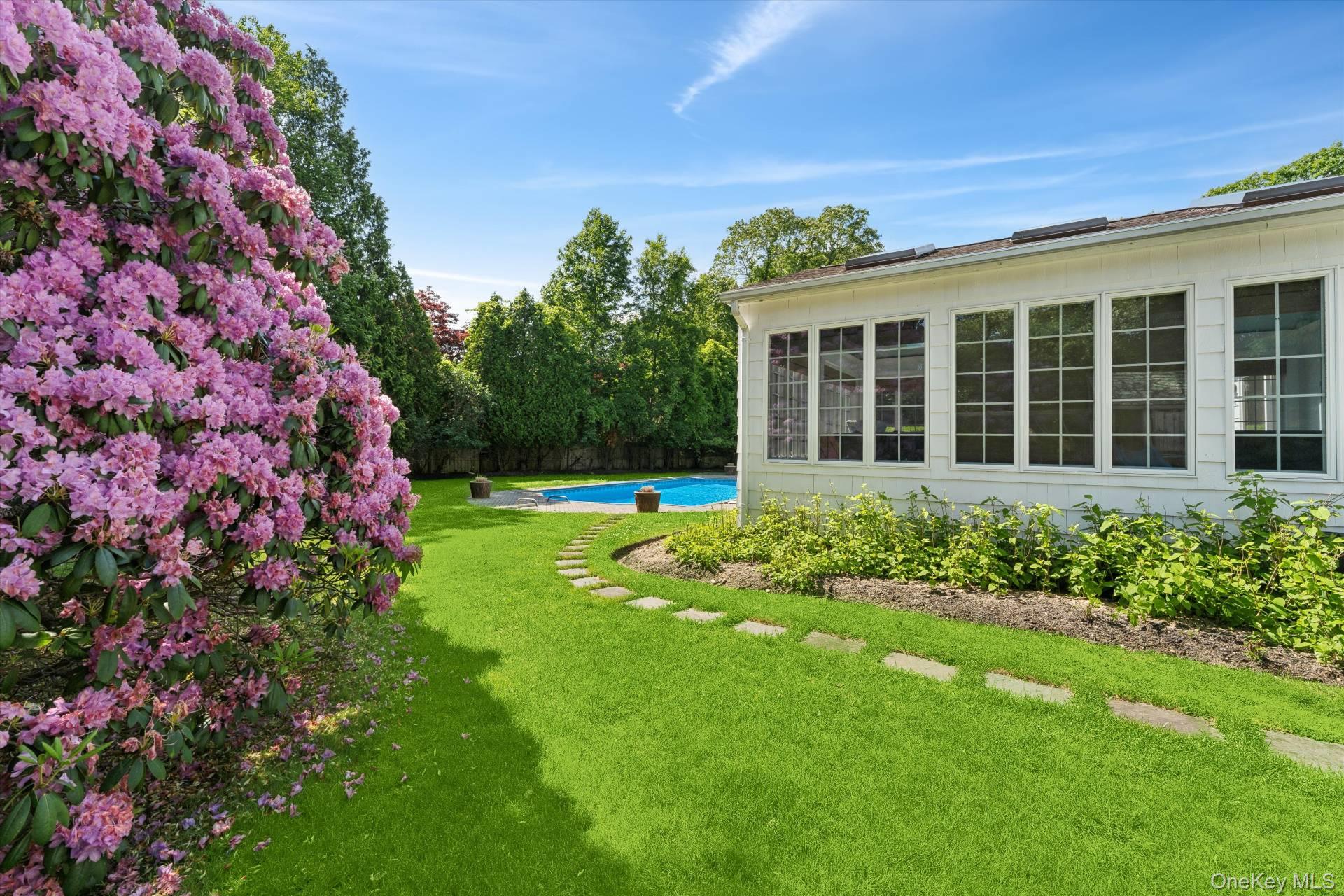 129 Oneck Lane Westhampton Beach, NY 11978 - Photo 25 of 32 a view of a house with a garden