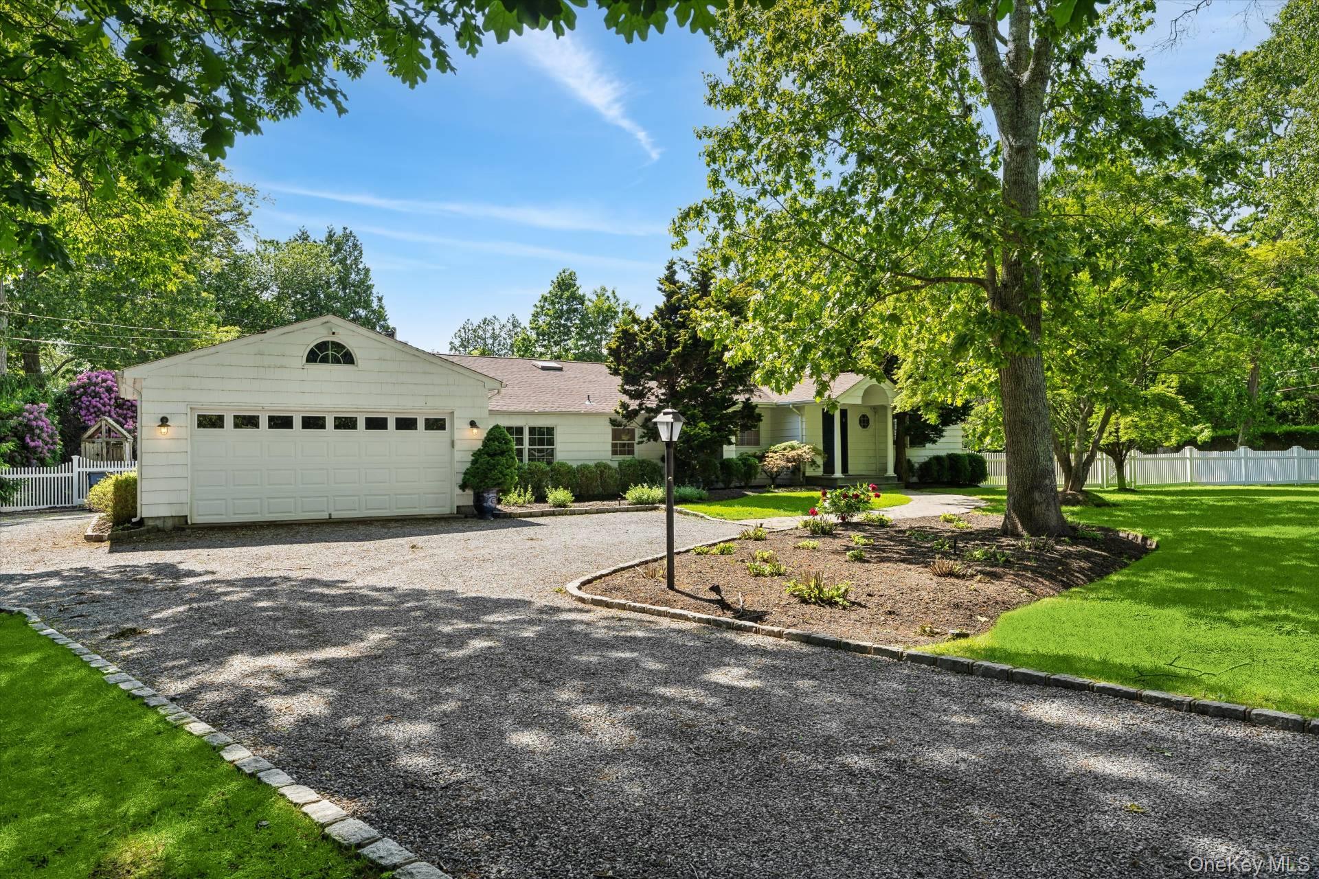 129 Oneck Lane Westhampton Beach, NY 11978 - Photo 30 of 32 a sign board with a big yard and large trees
