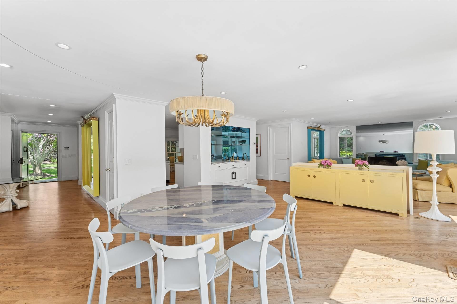 129 Oneck Lane Westhampton Beach, NY 11978 - Photo 6 of 32 a view of a dining room with furniture and wooden floor