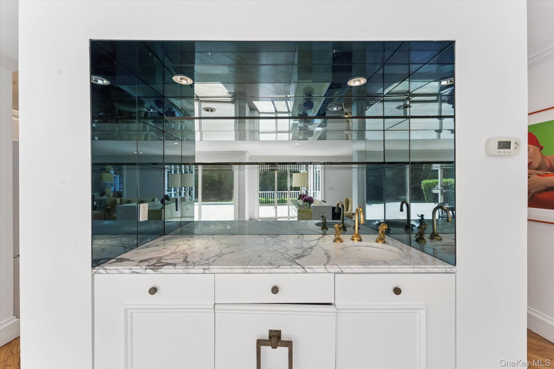129 Oneck Lane Westhampton Beach, NY 11978 - Photo 8 of 32 a kitchen with granite countertop white cabinets and a counter top space