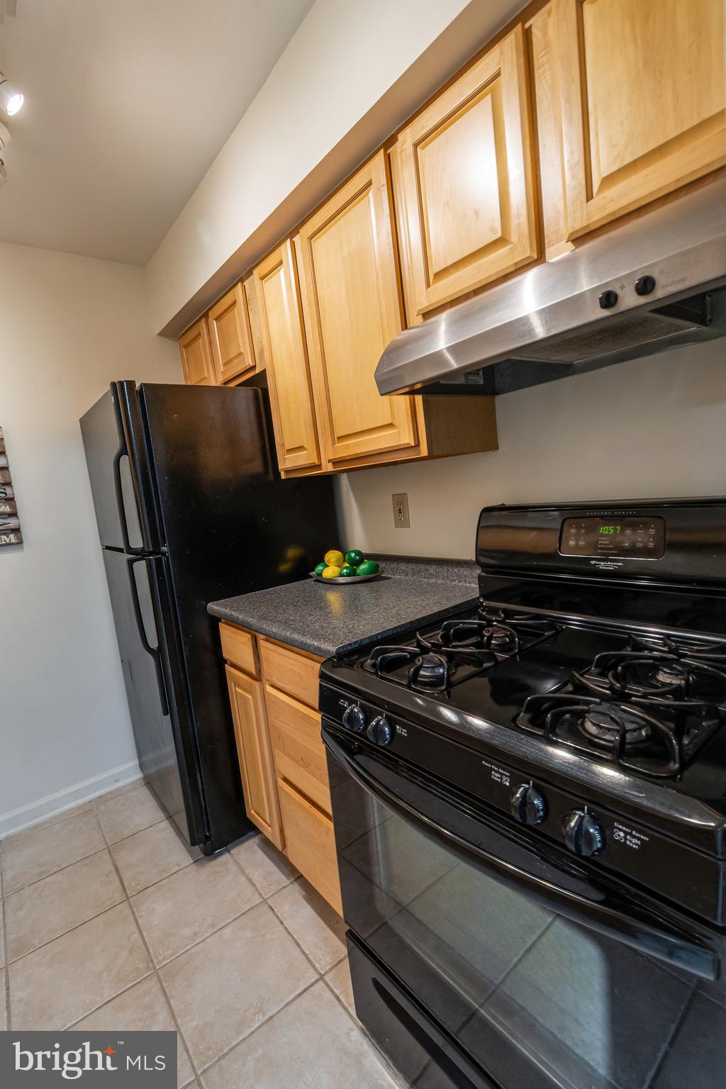 106 Mountain Road, Unit 1A Pasadena, MD 21122 - Photo 11 of 29 a kitchen with stainless steel appliances granite countertop a stove and a refrigerator