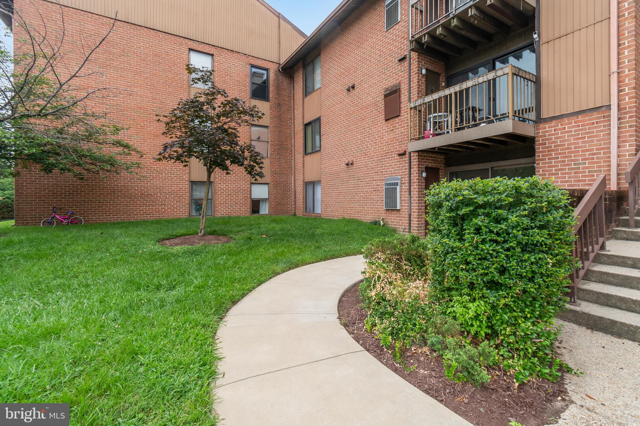 106 Mountain Road, Unit 1A Pasadena, MD 21122 - Photo 26 of 29 a front view of a house with garden