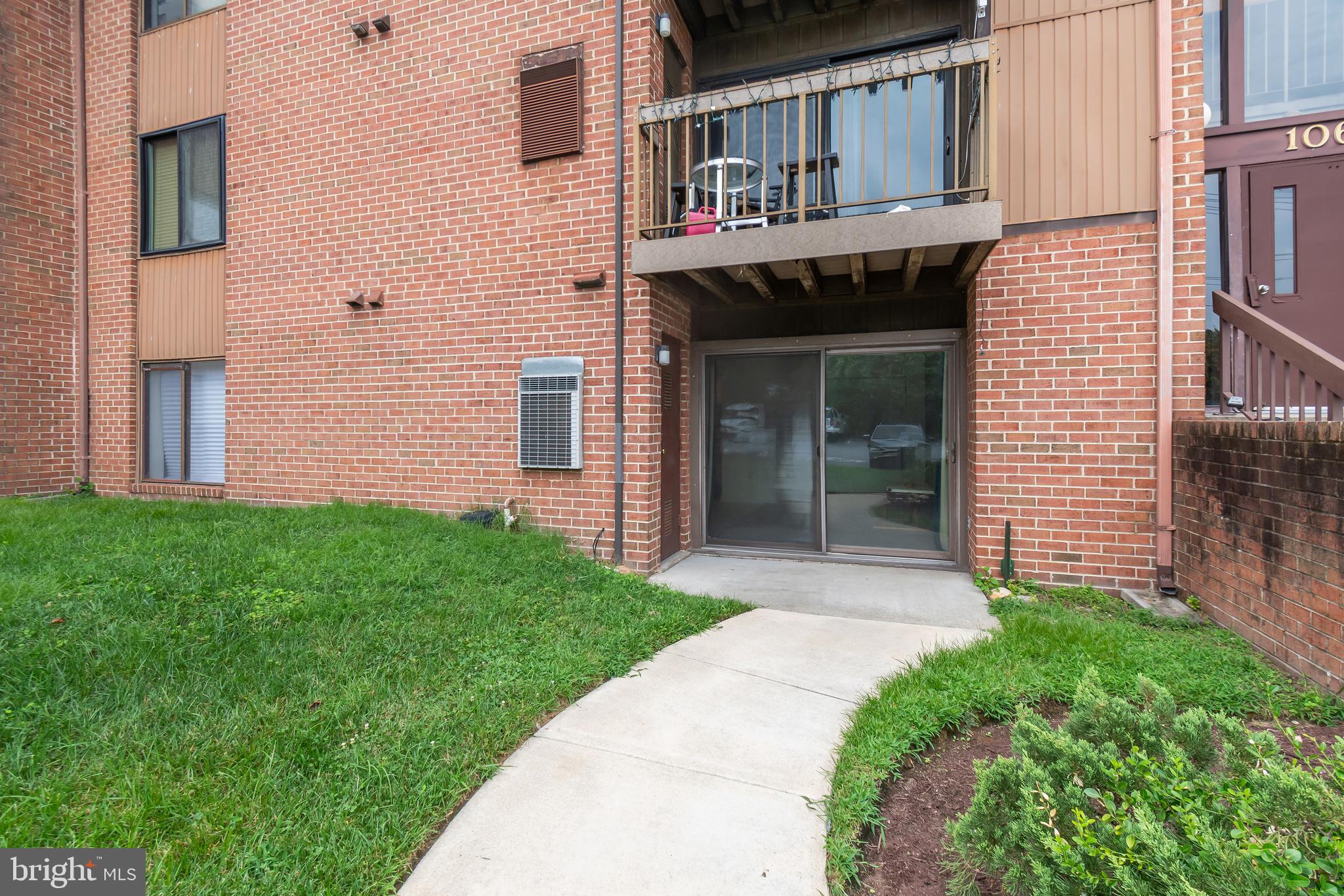 106 Mountain Road, Unit 1A Pasadena, MD 21122 - Photo 28 of 29 a front view of a house with garden