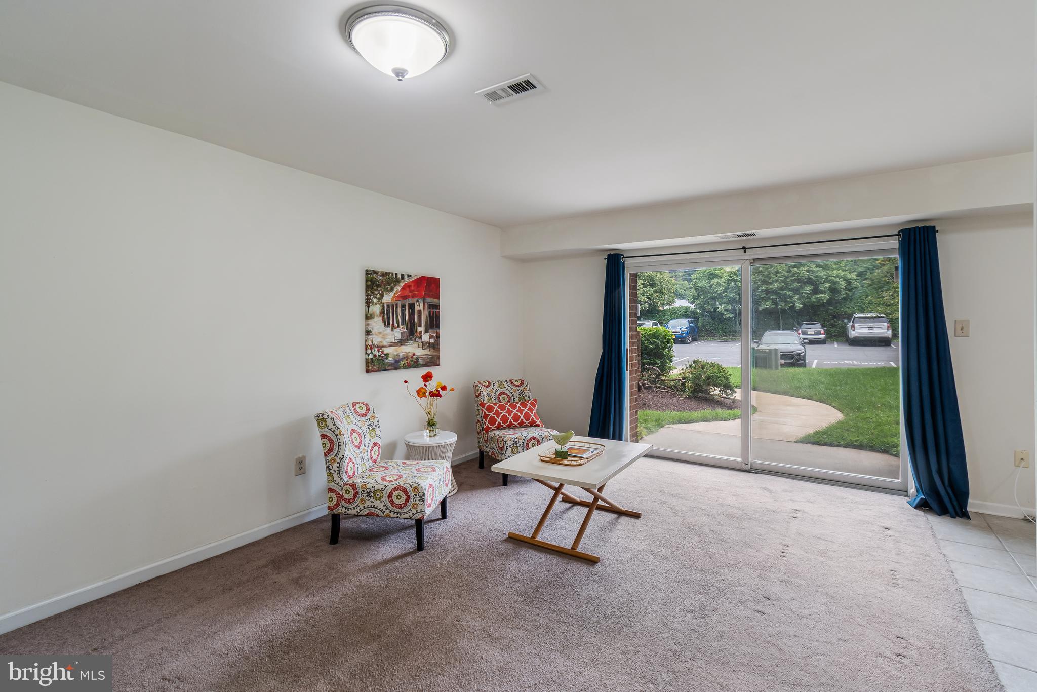 106 Mountain Road, Unit 1A Pasadena, MD 21122 - Photo 3 of 29 a living room with furniture and a floor to ceiling window
