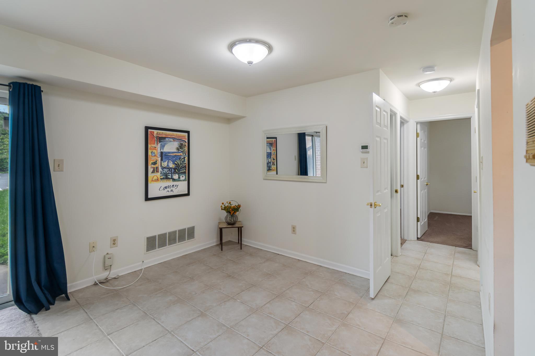 106 Mountain Road, Unit 1A Pasadena, MD 21122 - Photo 7 of 29 an empty room with windows and closet
