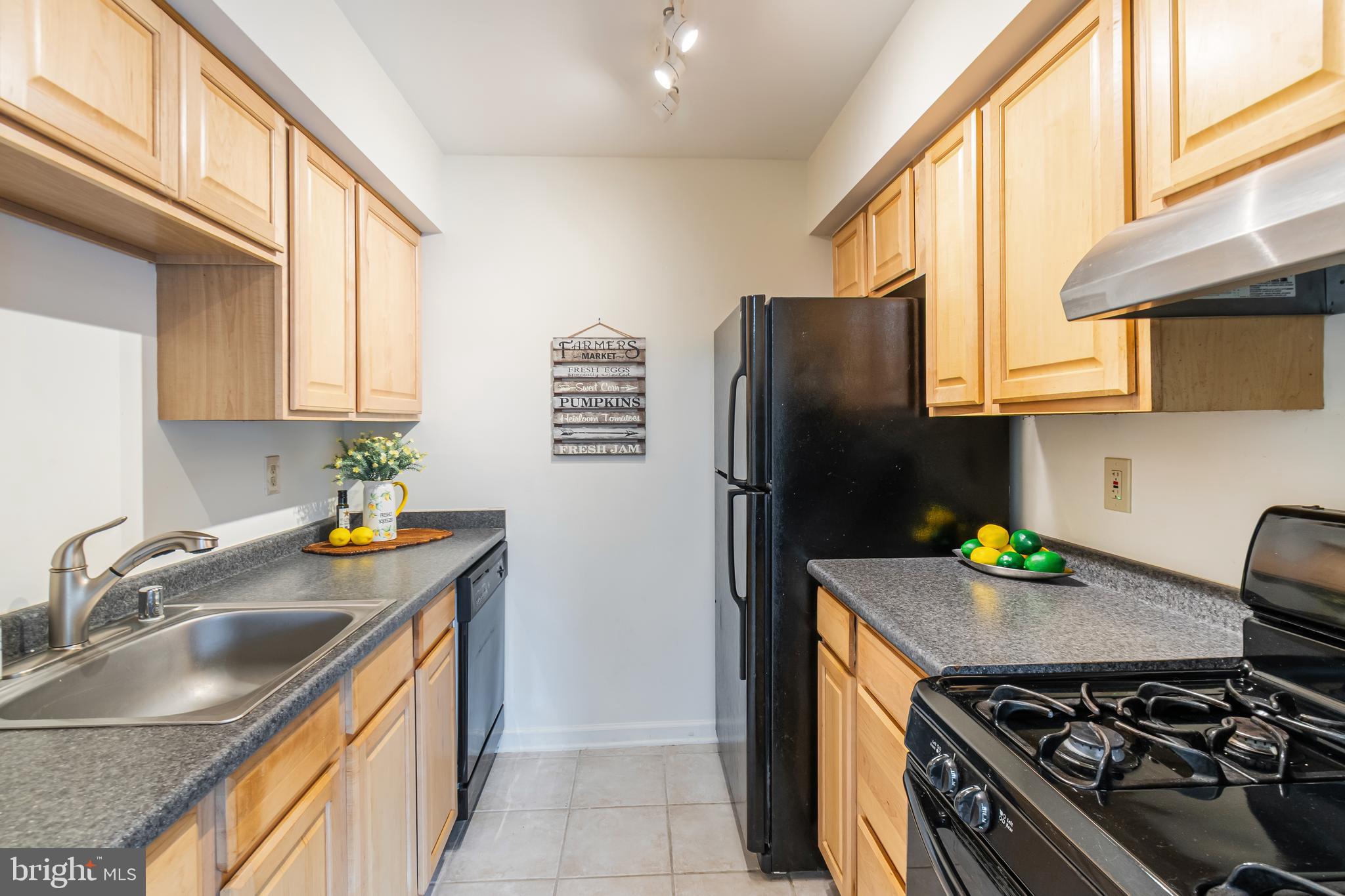 106 Mountain Road, Unit 1A Pasadena, MD 21122 - Photo 9 of 29 a kitchen with stainless steel appliances granite countertop a sink stove and refrigerator