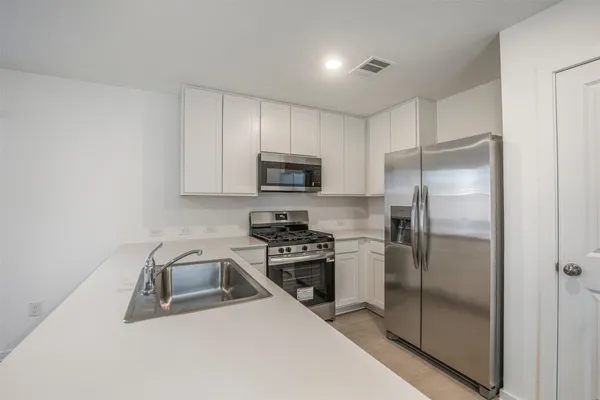 a kitchen with a refrigerator stove and microwave
