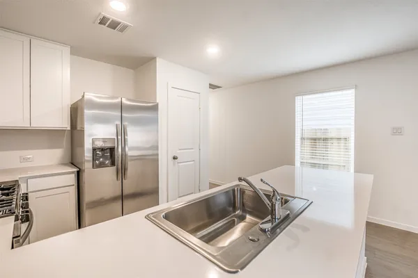 a room with a stove and a refrigerator