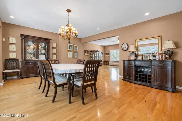 a dining room with furniture window and wooden floor