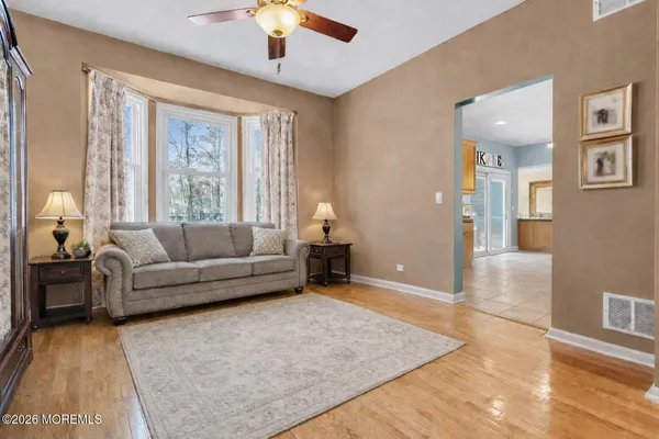a living room with furniture and a chandelier