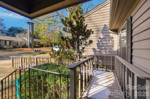 a view of balcony with wooden floor and fence