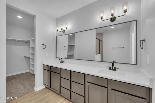 a bathroom with a sink double vanity and a mirror