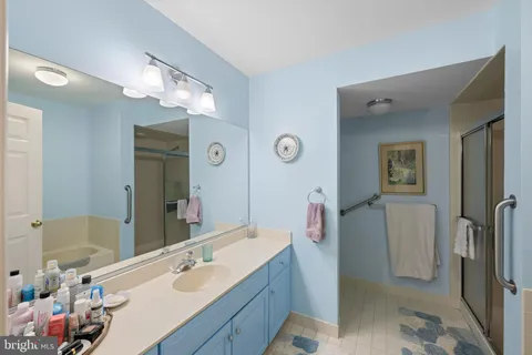 a bathroom with a sink vanity and a mirror