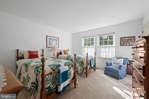 a bedroom with two beds and a couch