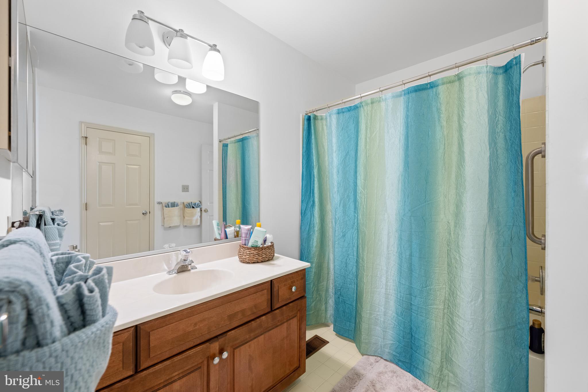 32 Manchester Court, Unit 32 Berwyn, PA 19312 - Photo 26 of 27 a bathroom with a double vanity sink and a mirror