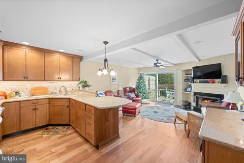 a kitchen with a sink stove and wooden cabinets