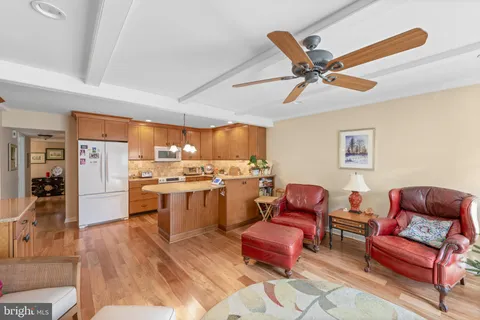 a living room with furniture and kitchen view