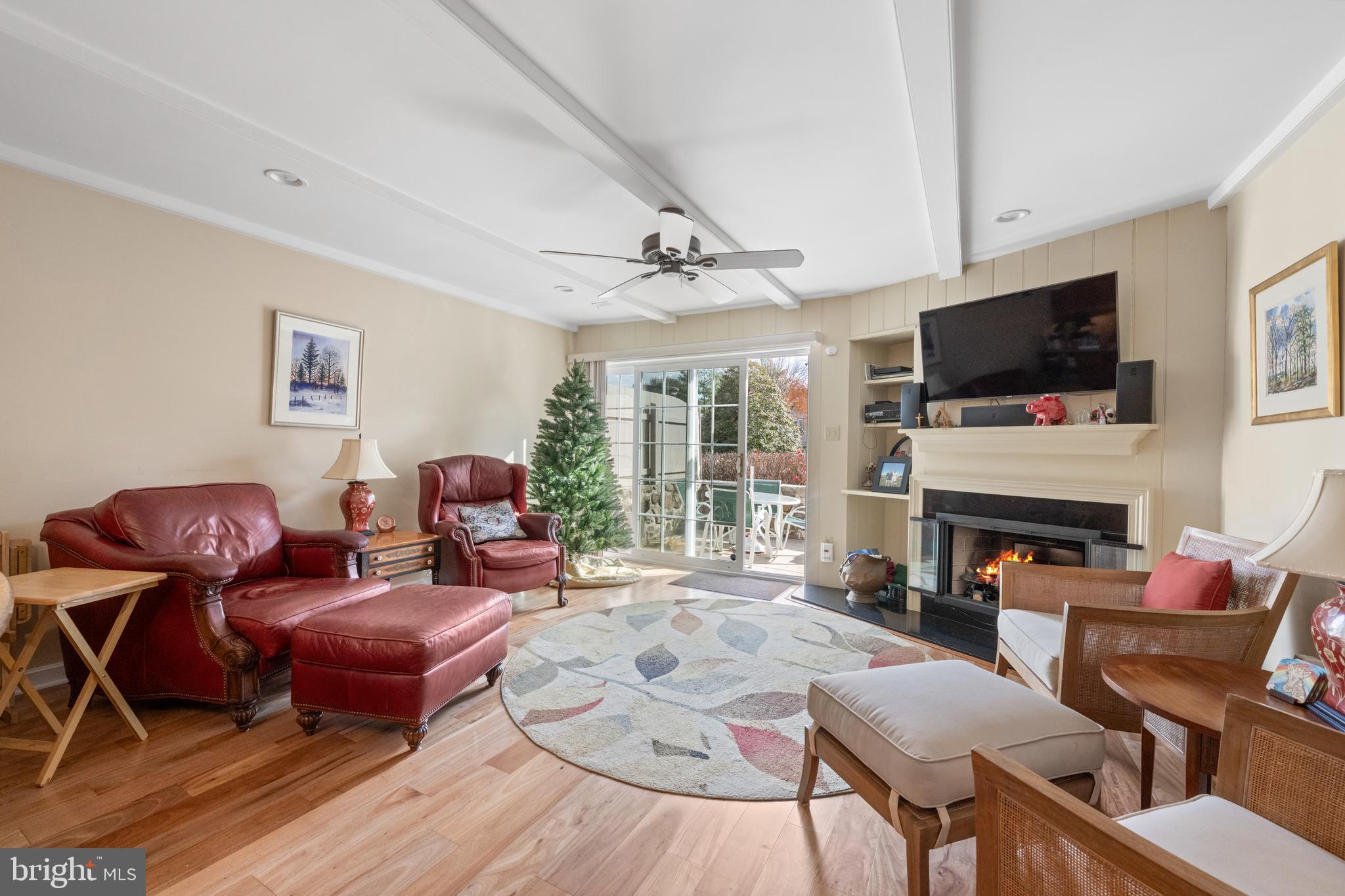 32 Manchester Court, Unit 32 Berwyn, PA 19312 - Photo 9 of 27 a living room with furniture a flat screen tv and a fireplace