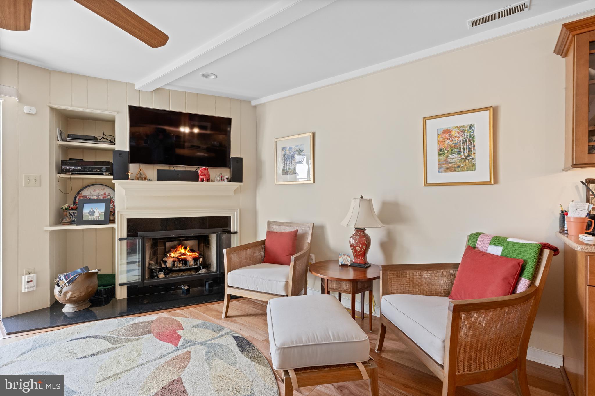 32 Manchester Court, Unit 32 Berwyn, PA 19312 - Photo 10 of 27 a living room with furniture a flat screen tv and a fireplace