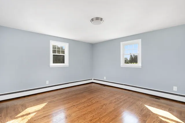 a view of a room with wooden floor and window