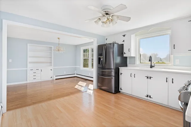 a kitchen with stainless steel appliances a refrigerator sink and cabinets