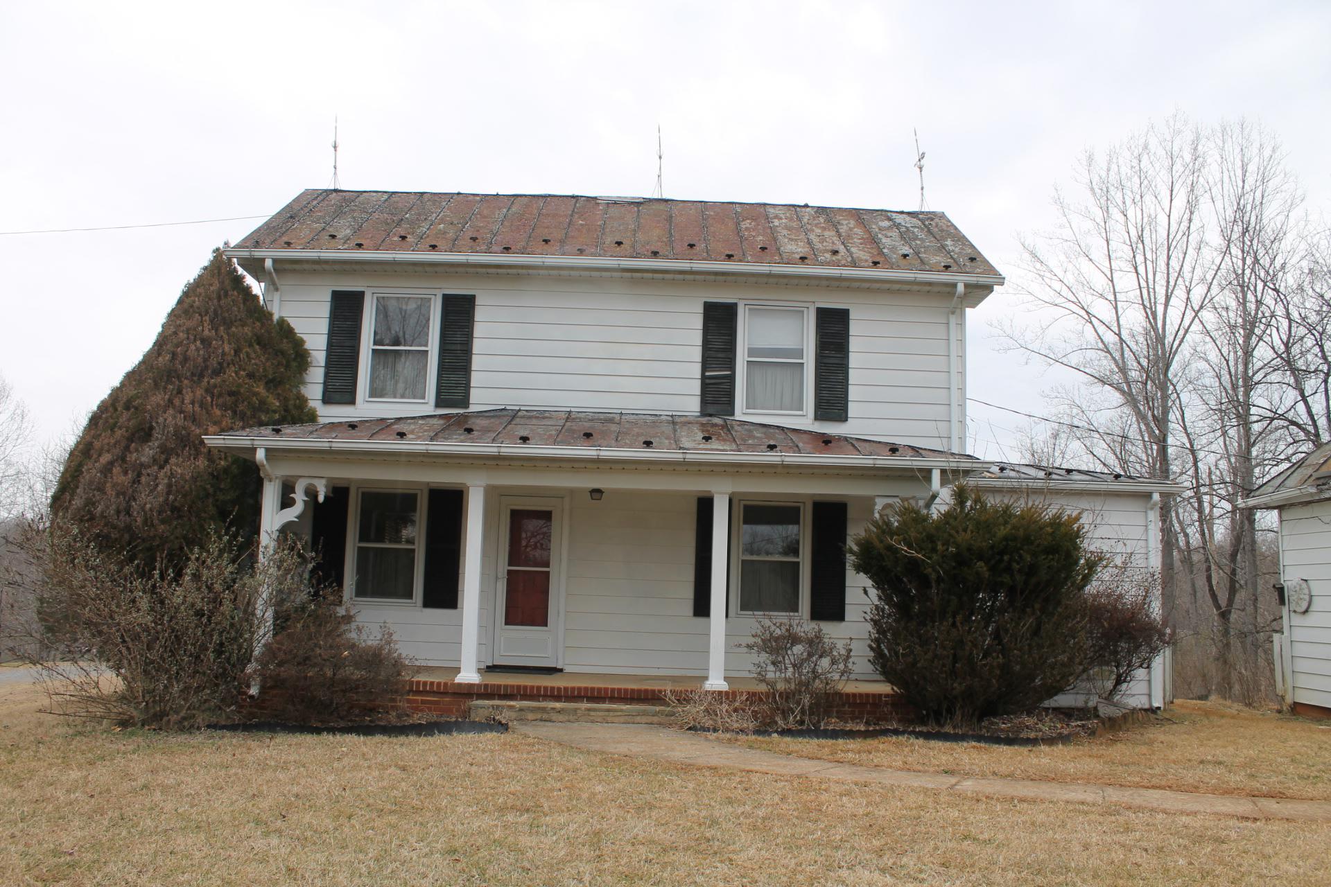 1153 Carters Island Road Goodview, VA 24095 - Photo 6 of 29 a front view of a house with a garden