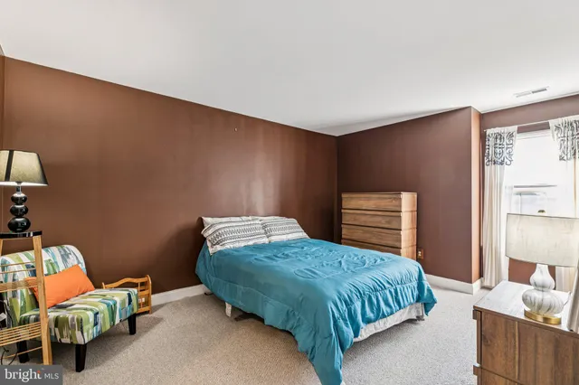 a bedroom with a bed and a lamp on table