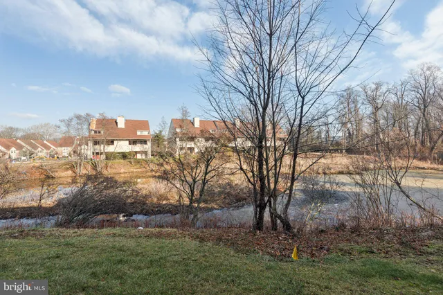a front view of a house with outdoor seating and a potted plant