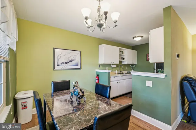 a living room with hard wood furniture and a table