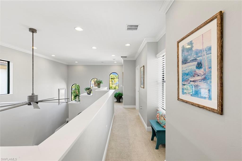 1350 Kendari Terrace Naples, FL 34113 - Photo 15 of 47 Corridor with light colored carpet, crown molding, recessed lighting, and an upstairs landing