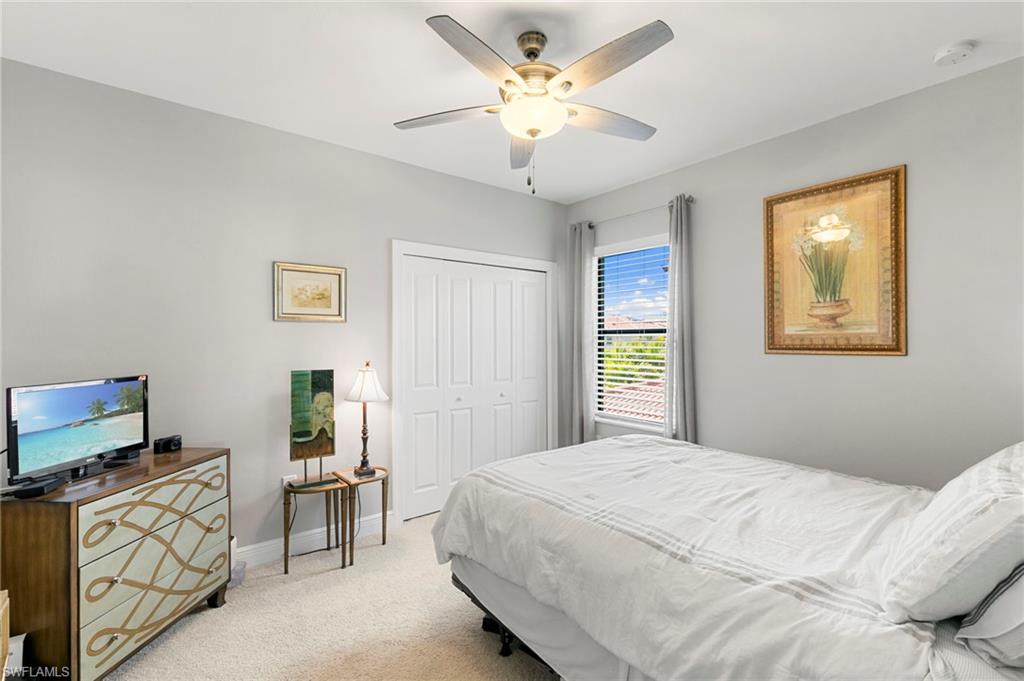 1350 Kendari Terrace Naples, FL 34113 - Photo 18 of 47 Bedroom featuring light carpet, ceiling fan, and a closet