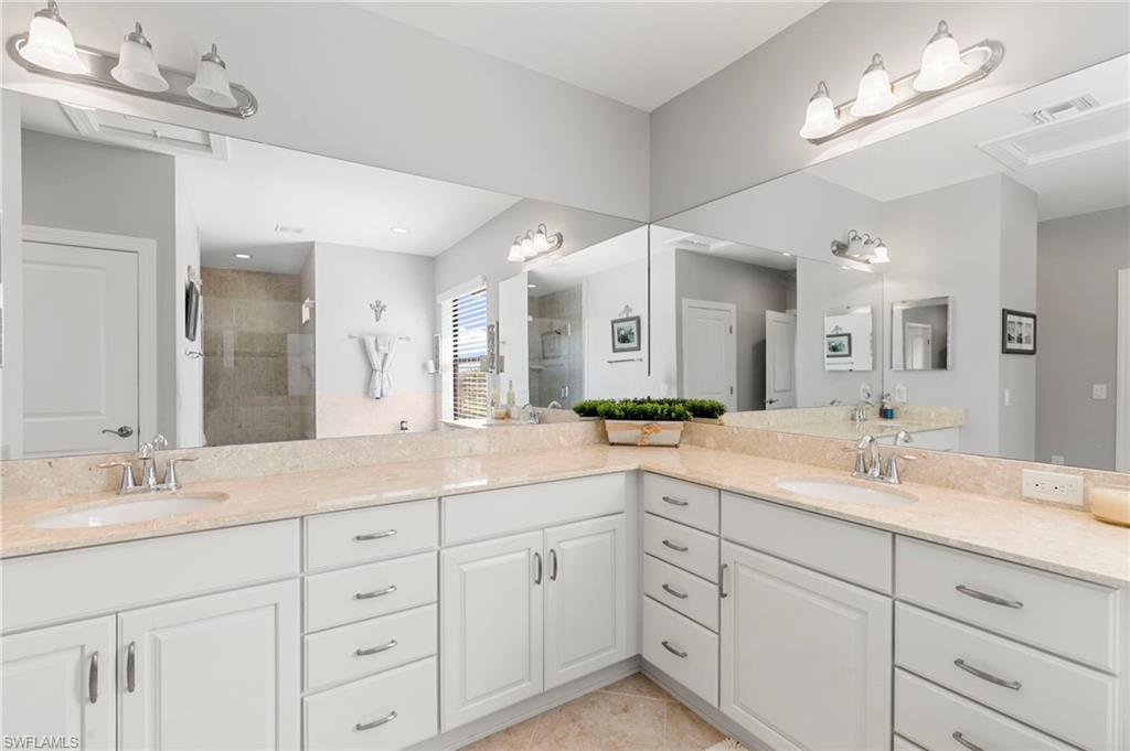 1350 Kendari Terrace Naples, FL 34113 - Photo 22 of 47 Full bathroom with double vanity, a stall shower, and light tile patterned floors