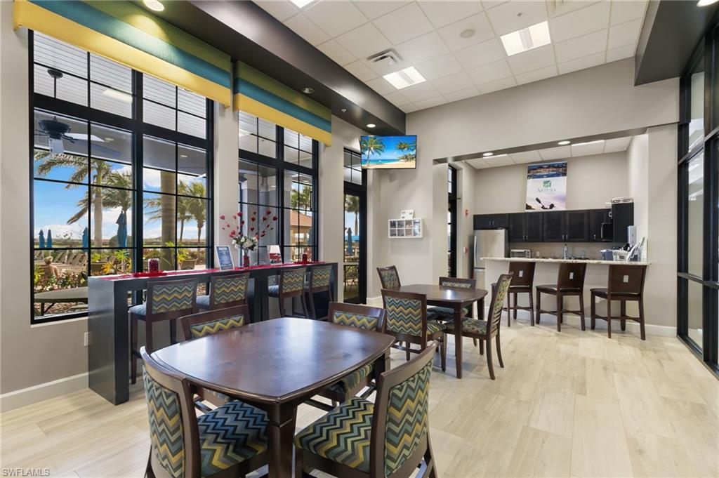 1350 Kendari Terrace Naples, FL 34113 - Photo 33 of 47 Dining area featuring a drop ceiling and light wood finished floors
