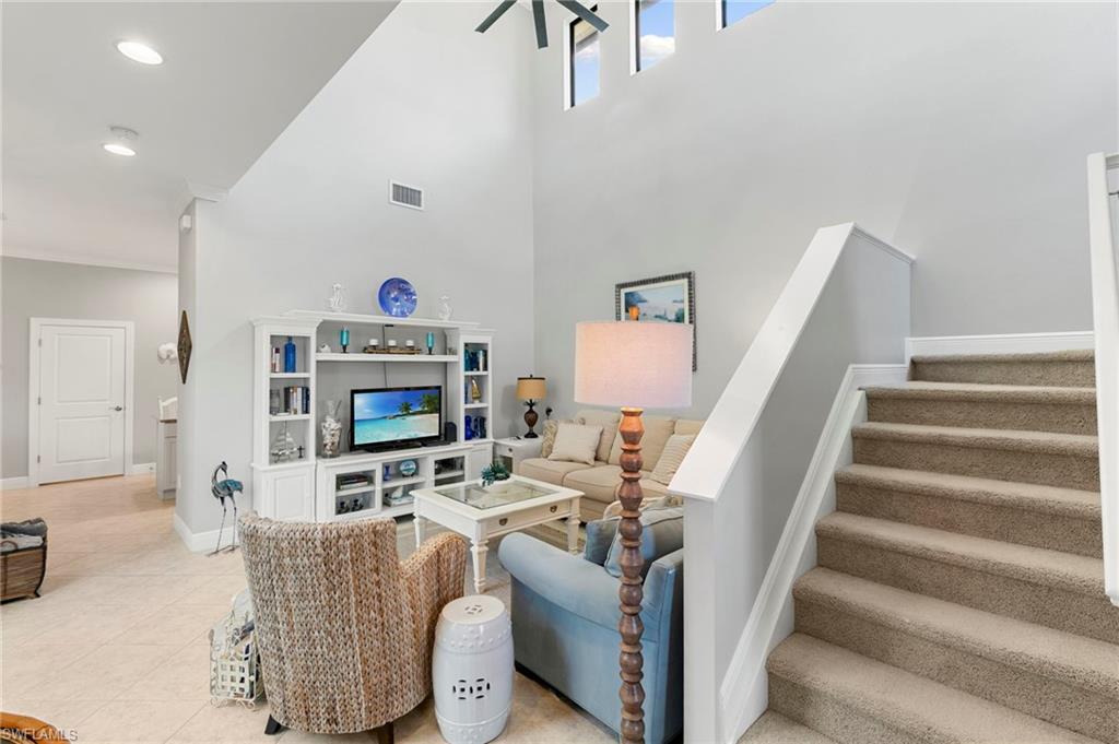 1350 Kendari Terrace Naples, FL 34113 - Photo 4 of 47 Living area with stairs, recessed lighting, and light tile patterned floors