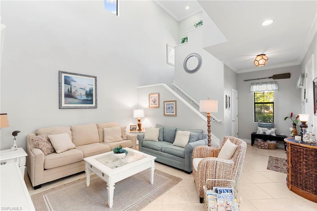 1350 Kendari Terrace Naples, FL 34113 - Photo 9 of 47 Living room featuring crown molding and light tile patterned flooring