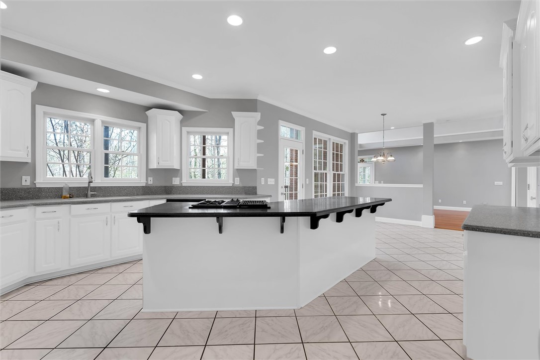 204 Red Maple Way Clemson, SC 29631 - Photo 13 of 48 This spacious kitchen features an expansive island and gleaming tiled floors.