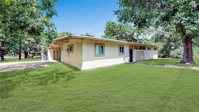 a front view of house with yard and green space