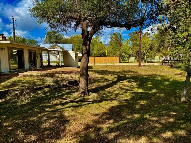 a view of yard with tree in the background
