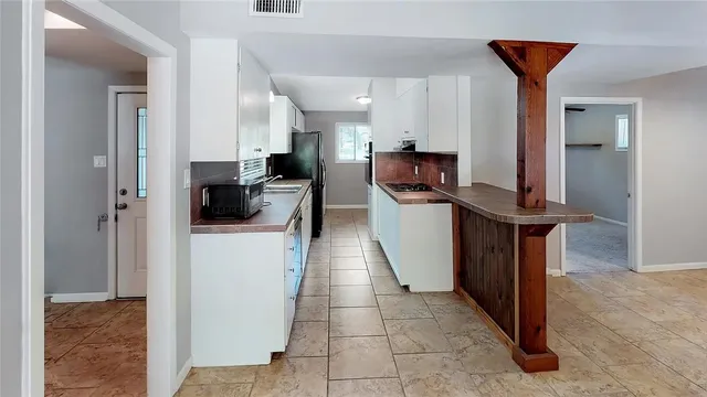 a kitchen with stainless steel appliances a refrigerator and a stove