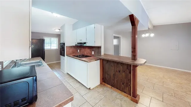 a kitchen with stainless steel appliances granite countertop a sink and a stove top oven