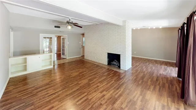 wooden floor in an empty room with a window